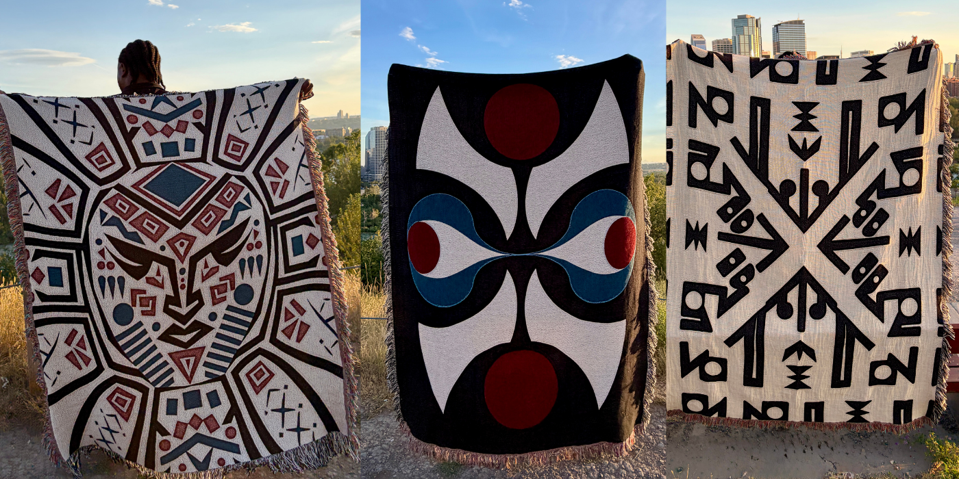 Three woven blankets with bold Southwestern geometric patterns are displayed outdoors against a blue sky. A person is visible from behind holding the leftmost blanket, and the center and right blankets are shown flat.