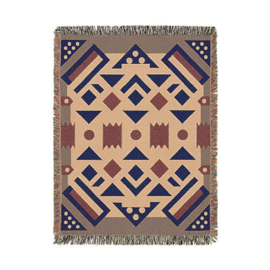A rectangular woven throw blanket with a Southwestern geometric pattern in beige, navy blue, and terracotta brown, finished with fringed edges.